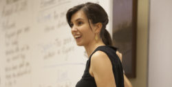 A teacher smiles expectantly at the class