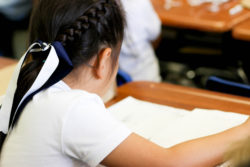 A student reads from her notebook