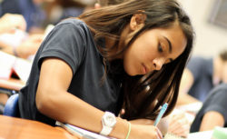 A student writes carefully in class