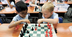Numerous children play chess together in competition