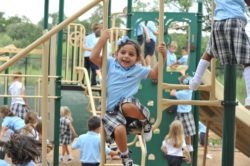 Students climb ladders and slide down swings