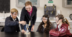 A teacher engages students in a science experiment.